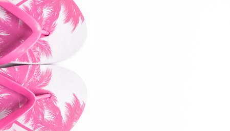 Trendy pink flip flops with palm trees print on white background. Vacation banner concept.の写真素材