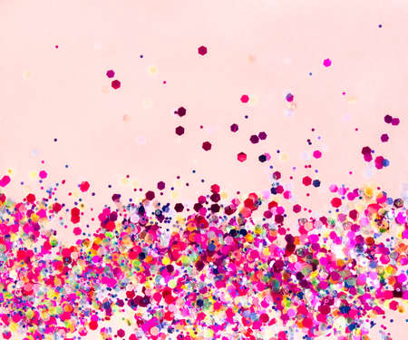 Sparkling and trandy holographic tinsels on pinkish background. Festive concept. Place for design.の写真素材