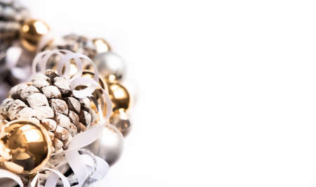 Silver and golden ornaments Christmas wreath on white background. Modern festive concept.の写真素材
