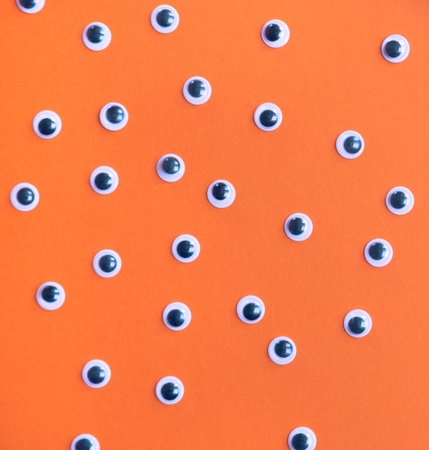 Halloween monster eyes trendy orange background. Funny holiday concept.の写真素材