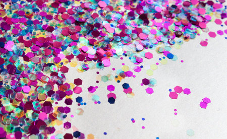Sparkling and trandy holographic tinsels on white background. Festive concept. Place for design.