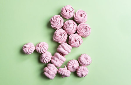 Black currant pink zephyr in beautiful rose shapes, marshmallow pattern on pastel mint green color.