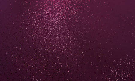 Splash of golden sparkles on dark wine colored burgundy background. Defocused festive concept.の写真素材