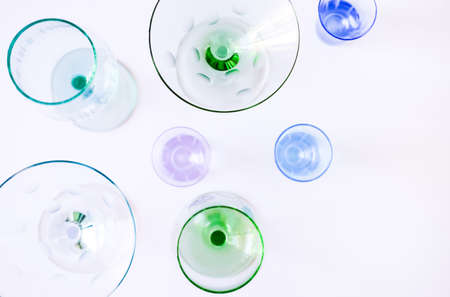Top view of several colorful wine and cocktail glasses on white background. Festive concept.の写真素材