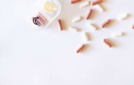 Pill case, herbal supplement in capsules and tablets on white background. Top view, healthcare concept.の写真素材