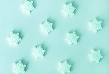 Monochrome mint blue Christmas snowflakes sugar sprinkles background. Flat lay style. Holiday trendy...