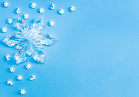 Blue white Christmas snowflakes background. Flat lay style. Holiday trendy minimal concept.