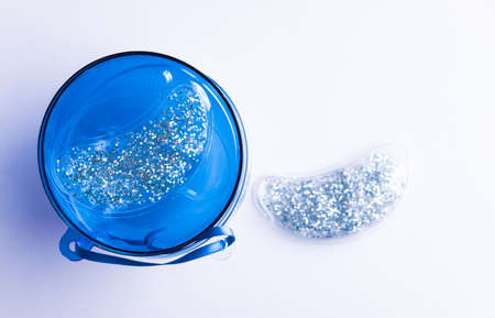 Silver glitter reusable cooling under eye pads. Cosmetic products concept. の写真素材