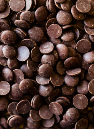 Dark couverture chocolate callets background. Modern food concept. の写真素材