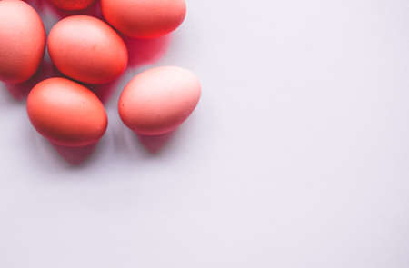 Red Easter eggs on pastel gray background. Holiday concept. Minimal composition.の写真素材