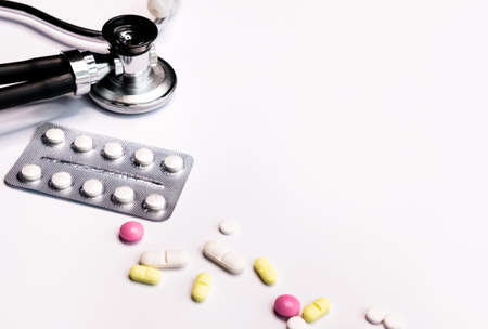 Professional silver black Stethoscope, blister pack and colorful pills on white background. の写真素材