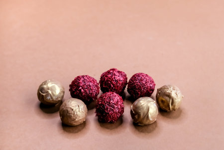 Dark and milk chocolate truffles on brown background. Modern chocolate design. 