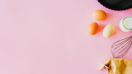 Baking ingredients, flour, milk and eggs on pink background. Food flat lay minimal concept.の写真素材