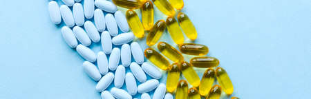 Colorful medicine pills and capsules on blue background banner.の写真素材