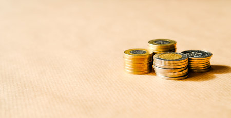 Stacks of coins over light background banner. Saving money concept.