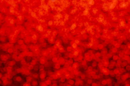 Red abstract defocused bokeh background. Festive concept. Selective focus.