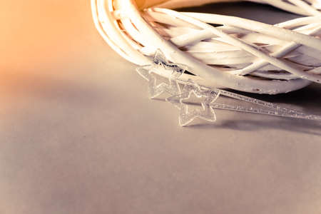 White wooden wreath and two silver stars on natural brown background. Festive Easter backdrop.の写真素材