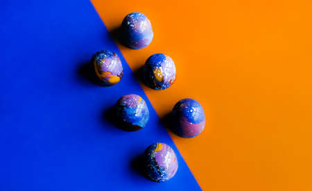 Colorful trendy blue molded chocolate pralines on vivid background. Modern chocolate design.の写真素材