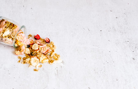 Breakfast cereal ingredients in glass jars on gray marble background. Ready-to-eat fast food concept. の写真素材