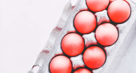 Red Easter eggs on pastel gray background. Holiday concept. Minimal composition.の写真素材