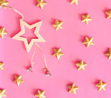 Golden stars glitter over pink background. Festive holiday backdrop.の写真素材