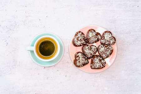 Black Coffee and chocolate cookies with coconut on gray marble background. Holidays food concept. の写真素材