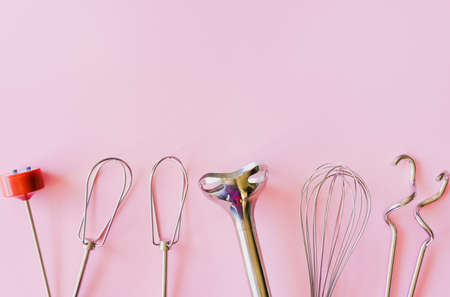 Baking tools, flour, different metal mixer whiskers on pink background.の写真素材