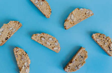 Freshly baked almond biscotti cookies pattern on blue background. Sweet food concept. の写真素材