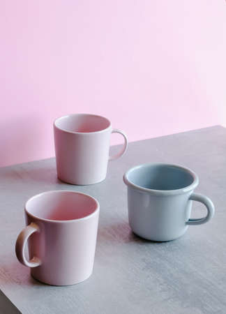 Classic coffee or tea cups on gray pink background. Minimal trendy pastel colored concept.の写真素材