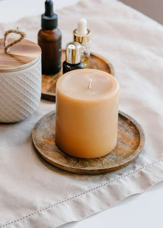 Aroma candles and essential oils on brown background. Spa beauty concept.の写真素材