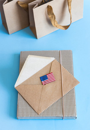 Zero waste concept, kraft brown paper bags and envelope, USA flag on blue white background.の写真素材