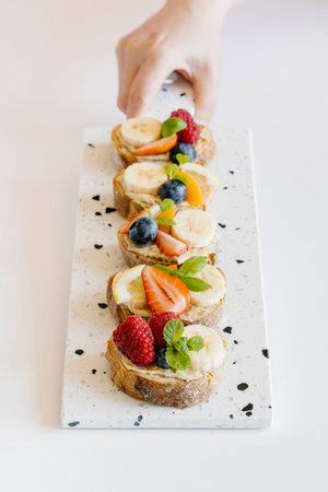 Summer fruit bruschetta with white chocolate spread, bananas, raspberries and strawberries....