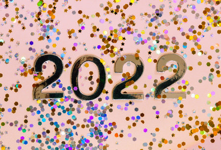 Silver number 2022 on shiny colorful glitter background.