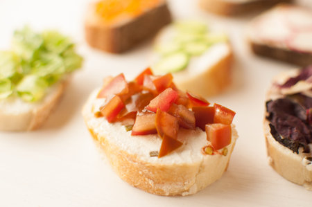 Mini sandwich set with french baguette, cheese, fish and avocado on white background top view mock...