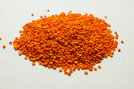 Raw red lentil on a white background. Macro Selective focus For vegetarianism and vegans.