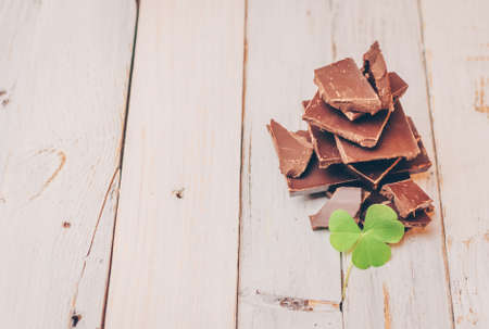 dark chocolate without sugar and gluten free for diabetics and allergics. Christmas tree made of chocolate pieces with a clover leaf. Copy space.の写真素材