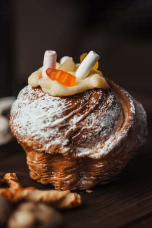 Stylish Easter cake with marshmallows and jelly bears on a dark rustic wooden background. Seasonal Greetings Happy Easter. place for text. Selective focus. modern happy easter imageの写真素材