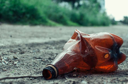 plastic bottle in the forest near the pond. Environmental pollution. Environmental issue and disaster. Go Green, Zero Waste, Save the Planet, Earth Day, No Plastic, Recycling Conceptの写真素材