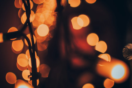 orange warm bokeh from the LED garland on the facade of the building. Concept of festive Christmas...