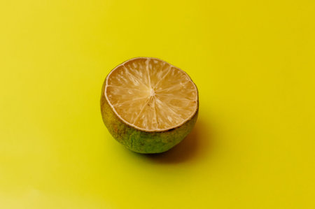 The concept of ugly fruits and citrus fruits. Half of sliced lime has dried and deteriorated on a...