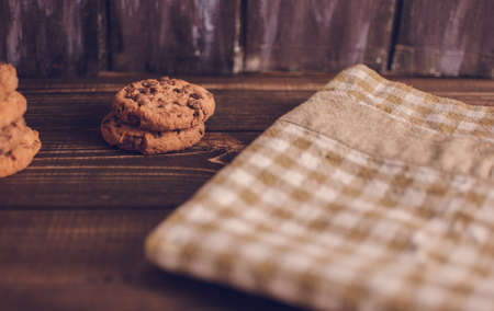 Oatmeal liver lies near the napkin in the box. Rustic table. Vintage toning. Dietary useful cookies without gluten. Copy space.の写真素材