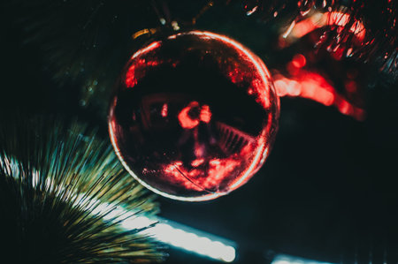 Decorated Christmas tree close-up. Red balls and a garland with illumination with lanterns. New...