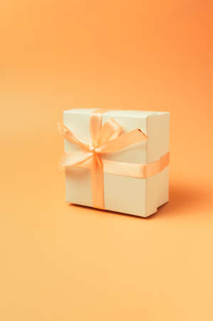 vintage light boxes with a light orange bow on a peach isolated background. Soft toning. Template for design, copy space.の写真素材