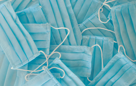 Background of blue disposable medical protective masks.