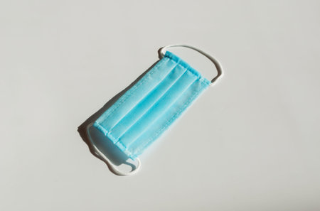 blue disposable medical protective mask. Preparation for departure for patients covid-19. Concept of...
