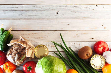 various products on a white wooden table, flat lay. Space for text. Concept of buying food during a crisis. Top view.の写真素材