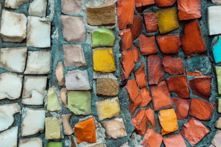 Detail of a beautiful multi-colored old crumbling abstract ceramic mosaic decoration on a building. Venetian mosaic as a decorative background. Selective focusの写真素材