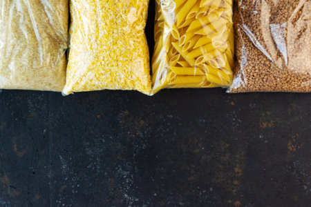 Food supply quarantine food crisis isolated on black concrete background. Rice, pasta, corn flakes,...