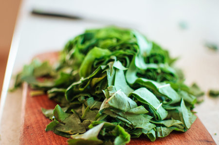 Fresh organic sorrel,plant spinach heap on wooden table for spring green vegetables soup and...