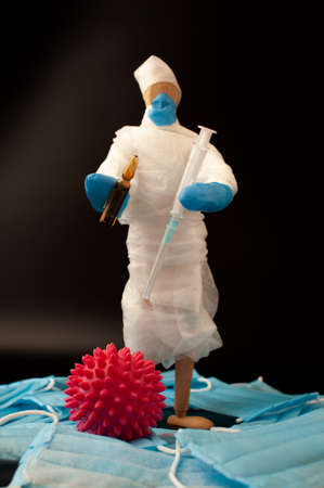 The global epidemic of coronavirus.man in protective medical uniform is holding antibiotics from COVID-19 in his hands.The concept of protecting and controlling outbreaks of the SARS epidemic.の写真素材